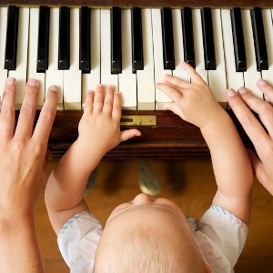 Adult and Child playing piano